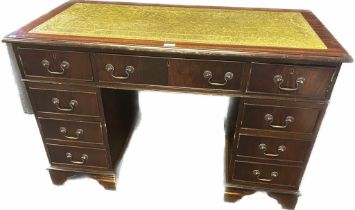 Reproduction mahogany partners desk, the surface fitted with green leather above an arrangement of