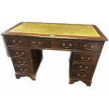 Reproduction mahogany partners desk, the surface fitted with green leather above an arrangement of