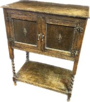 Arts and crafts oak cabinet, the rectangular top above the two cupboard doors, the lower with