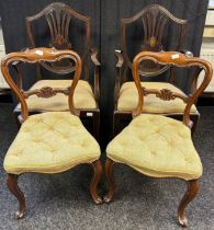 A group of 19th Century chairs covered in a natural upholstery