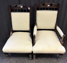 19th Century oak His and Her chairs, the whole cushioned in a neutral upholstery raised on turned