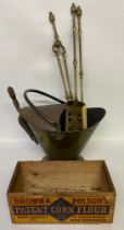 An Antique brass coal skuttle, fire dog utensils along with Brown polson antique advertising corn