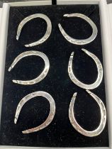 A Set of six Sheffield silver Equestrian horse shoe napkin rings. Produced by Francis Howard Ltd. [