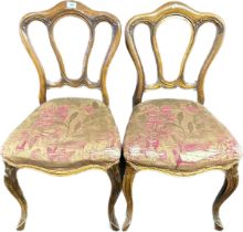 A pair of Victorian mahogany dinning chairs raised on carved cabriole legs