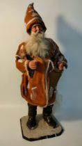 Antique sculpture model of father Christmas supported on a wooden plinth