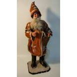 Antique sculpture model of father Christmas supported on a wooden plinth