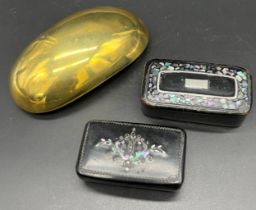 Three 19th century snuff boxes; Brass cap shaped snuff and two lacquered snuff boxes.