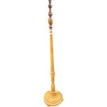 Antique mahogany standard lamp raised on a circular base ending on bun feet. [153cm]