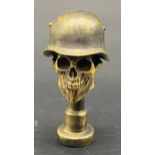 Bronze pipe tamper in the form of a skull