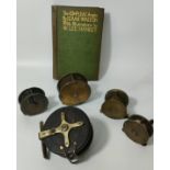 Antique brass and wood fishing reels together with Isaac Walton book