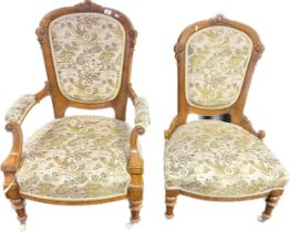 Victorian walnut his and her chairs covered in a needlework upholstery, raised on turned legs ending