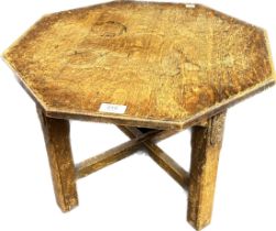 Antique oak octagonal table raised on blocked carved legs supported by a stretcher.