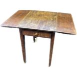 Antique oak table, with drop ends above a single end drawer, raised on square tapered legs ending in