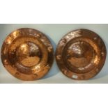 A pair of Scottish arts n crafts style copper wall chargers [39cm]