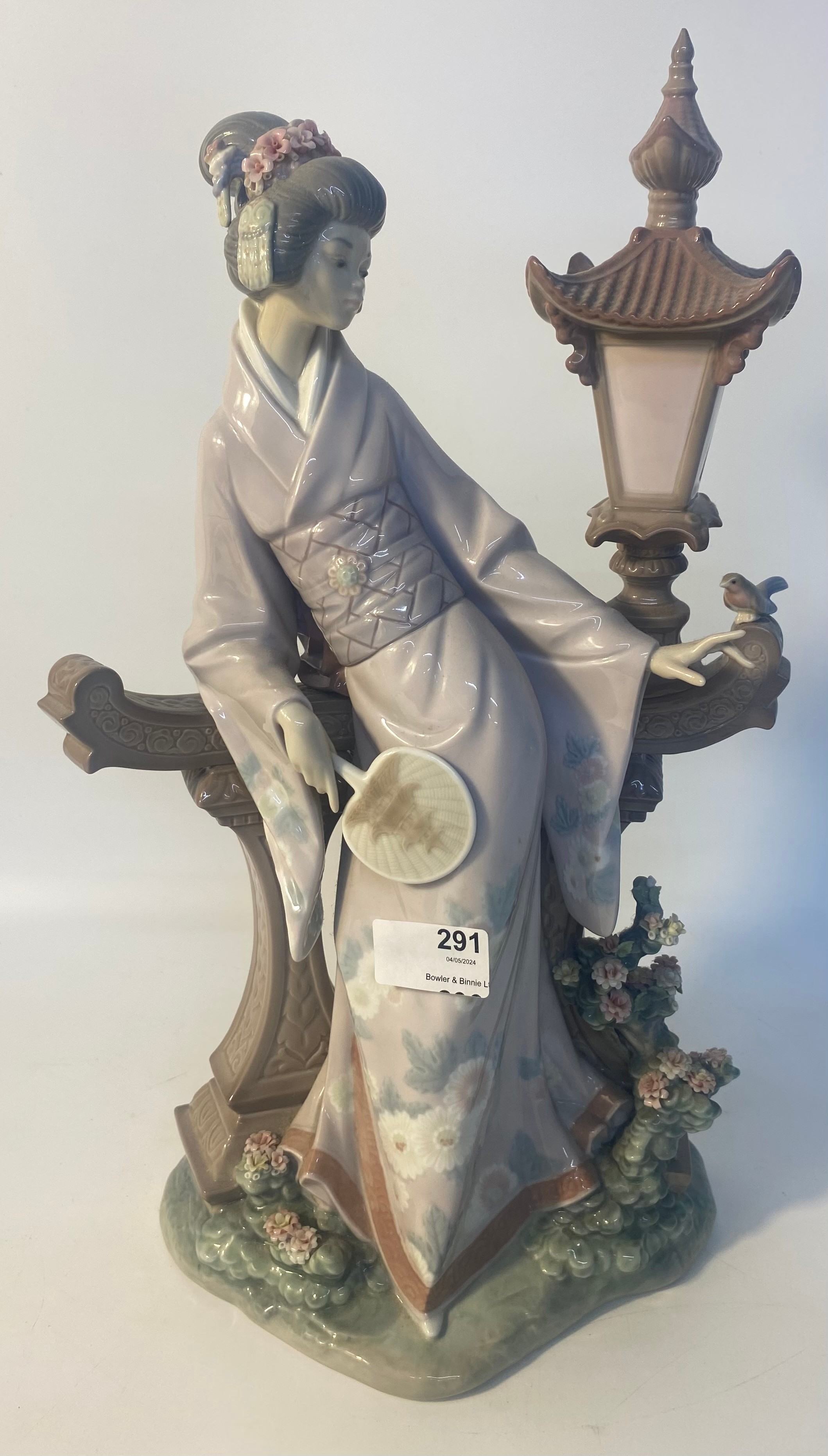 A large Lladro figure of a geisha in the garden [41.5cm]
