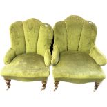 Pair of art deco cushioned chairs, covered in a green upholstery, raised on turned tapered legs