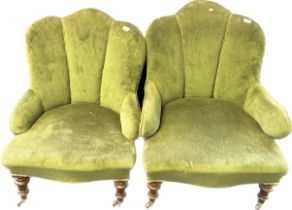 Pair of art deco cushioned chairs, covered in a green upholstery, raised on turned tapered legs