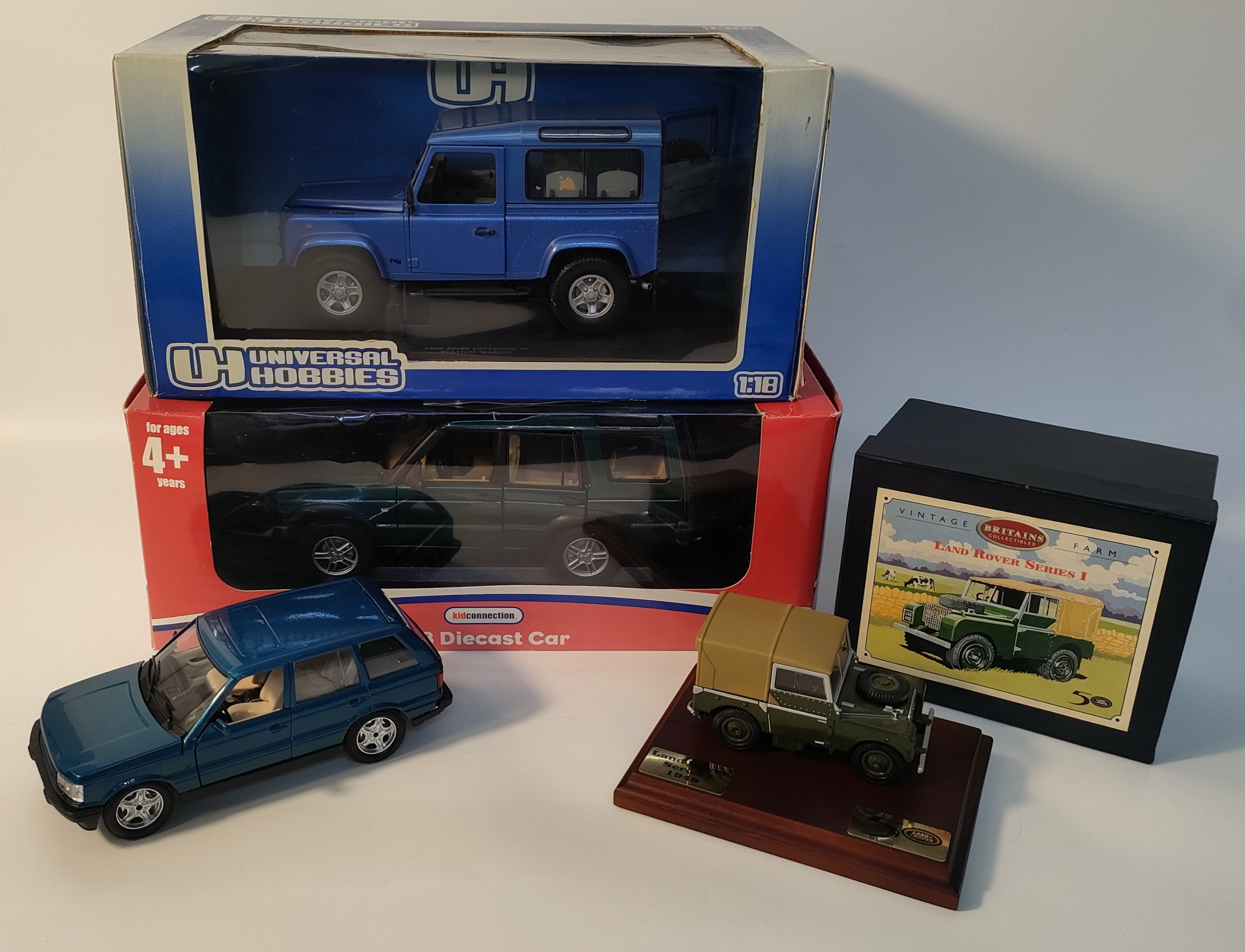 Collection of four land rovers models; Britain's Land rover series one with plinth & universal