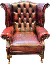 Chesterfield Gullwing chair, covered in a red leather button upholstery