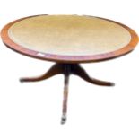 Reproduction leather topped coffee table, raised on out swept legs ending in brass castors