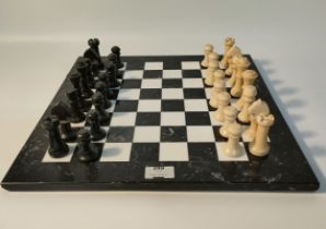 A vintage Marble black & white chess board with 32 pieces