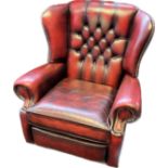 Chesterfield reclining lounge chair, covered in a red leather button upholstery