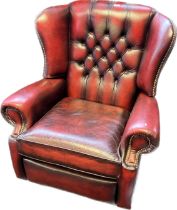 Chesterfield reclining lounge chair, covered in a red leather button upholstery