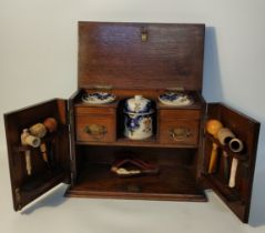 Oak 19th century tobacconist cabinet with collectable pipes; Amber mersham style pipe & porcelain