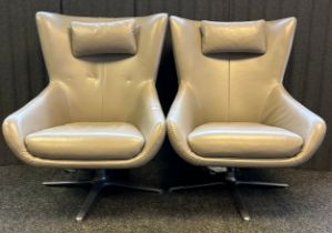 Pair of Italian design swivel arm chairs covered in a grey leather upholstery [100x66x90cm]