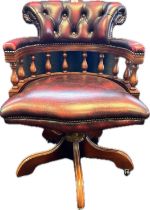 Chesterfield captains swivel chair covered in an oxblood button leather upholstery