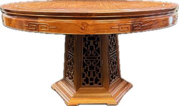 Chinese Rosewood table, the circular top above a hexagonal tapering carved base