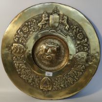 Antique British brass wall charger depicting coat of arms & shield crests with lion centre [54x53cm]