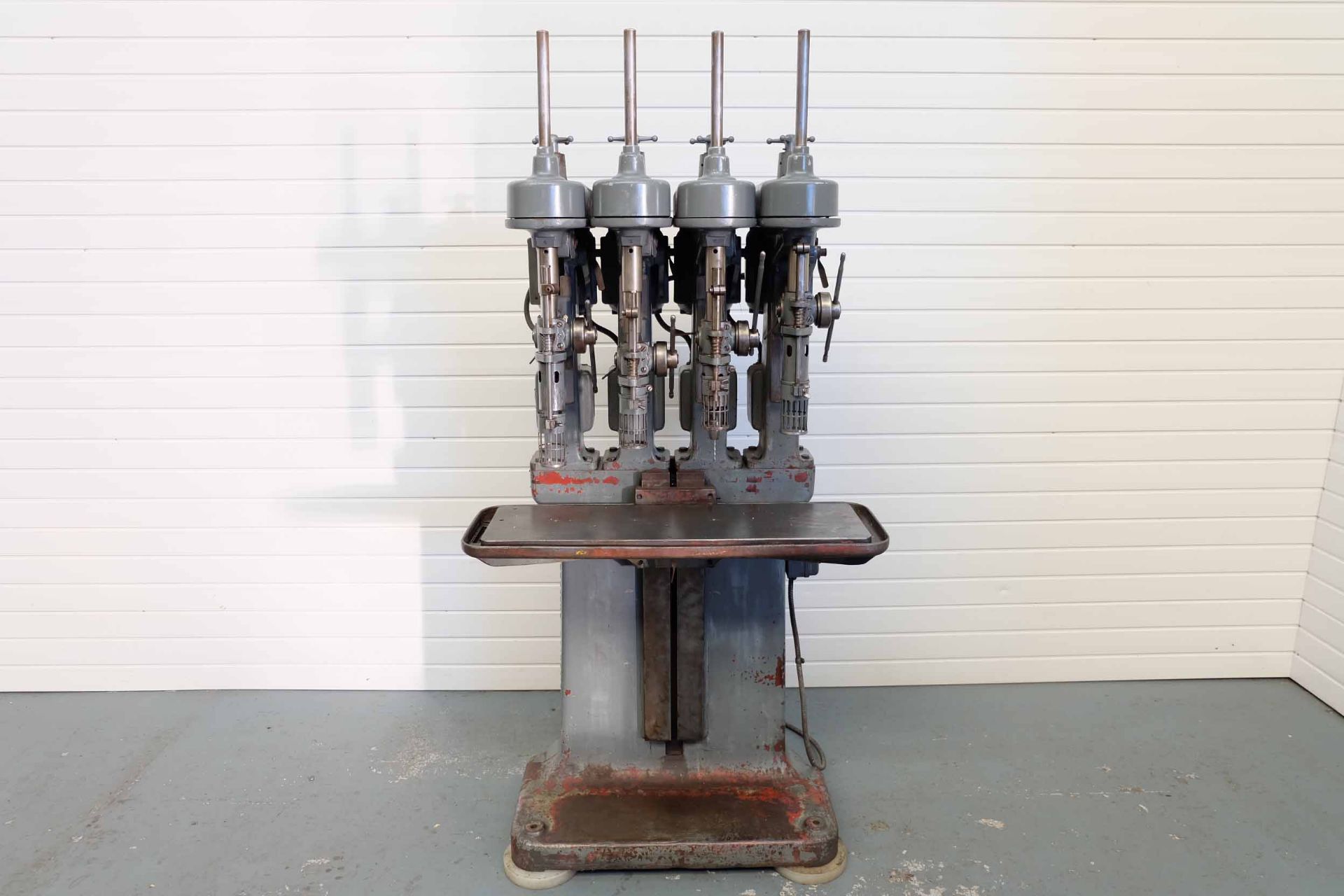 Pollard Corona Model 1EX 4 Spindle In-Line Drilling Machine. Table Size 33" x 10". Throat 7". Spindl