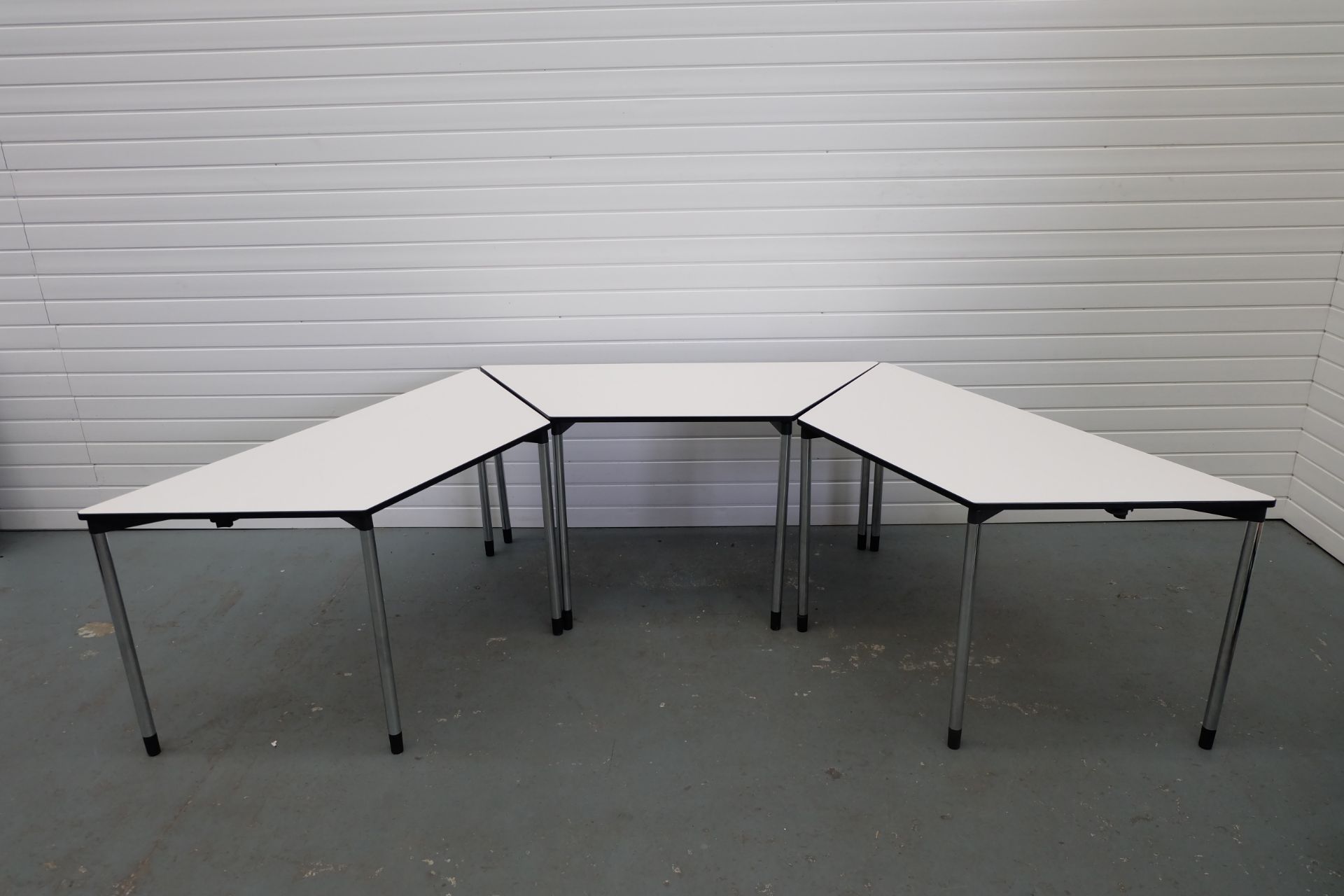 3 x Trapeziod Shape Desks With Metal Legs. Size 1470mm x 650mm x 750mm High.