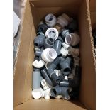 Box of assorted PVC fittings.