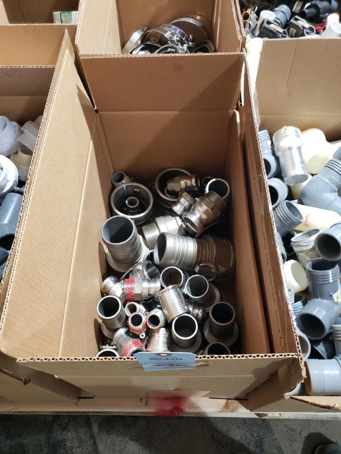 Box of assorted stainless fittings.