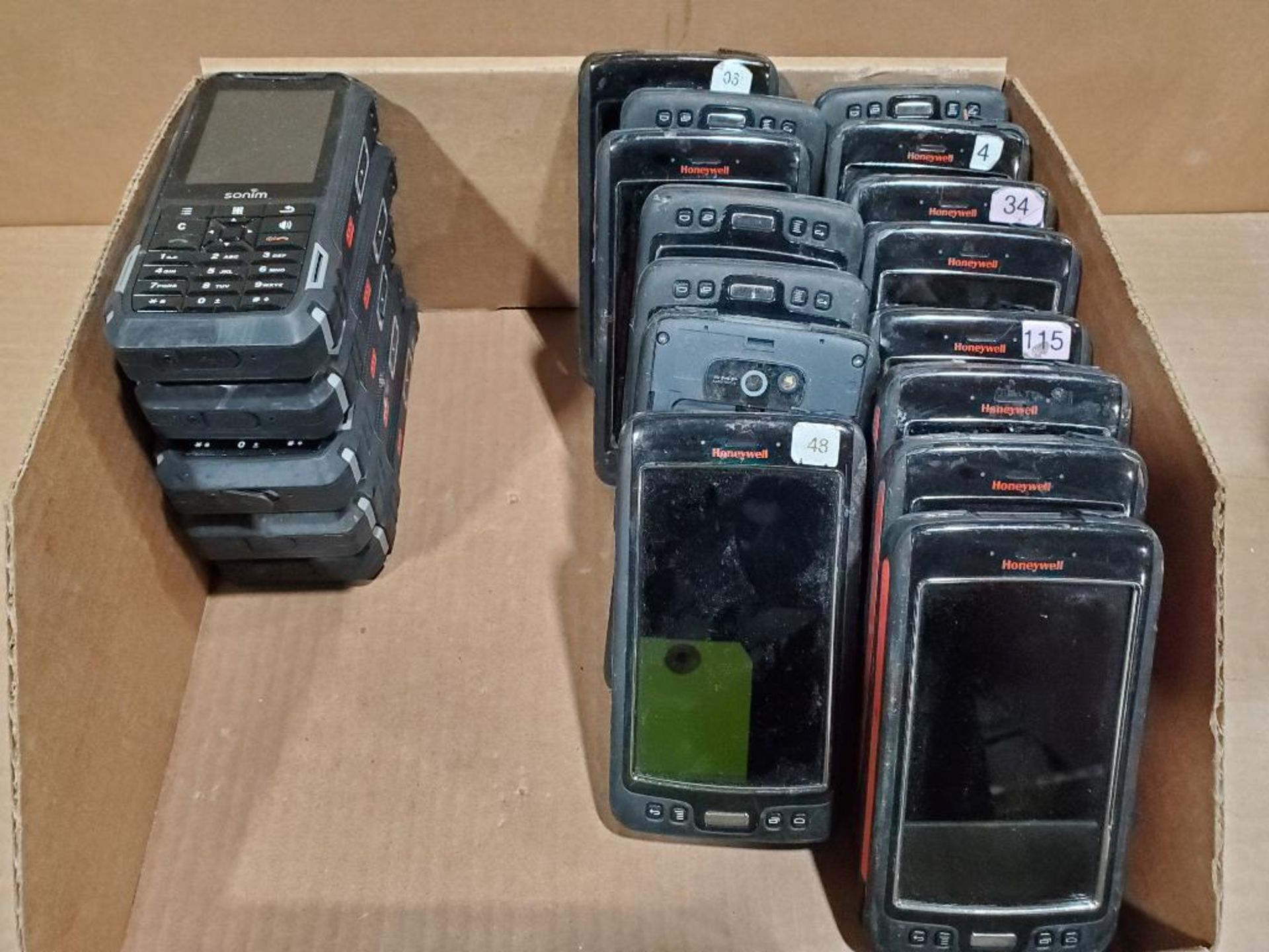 Assorted Honeywell and Sonim handheld units.