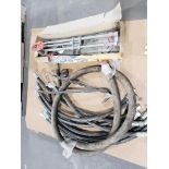 Assorted hydraulic hoses and tile cutter.