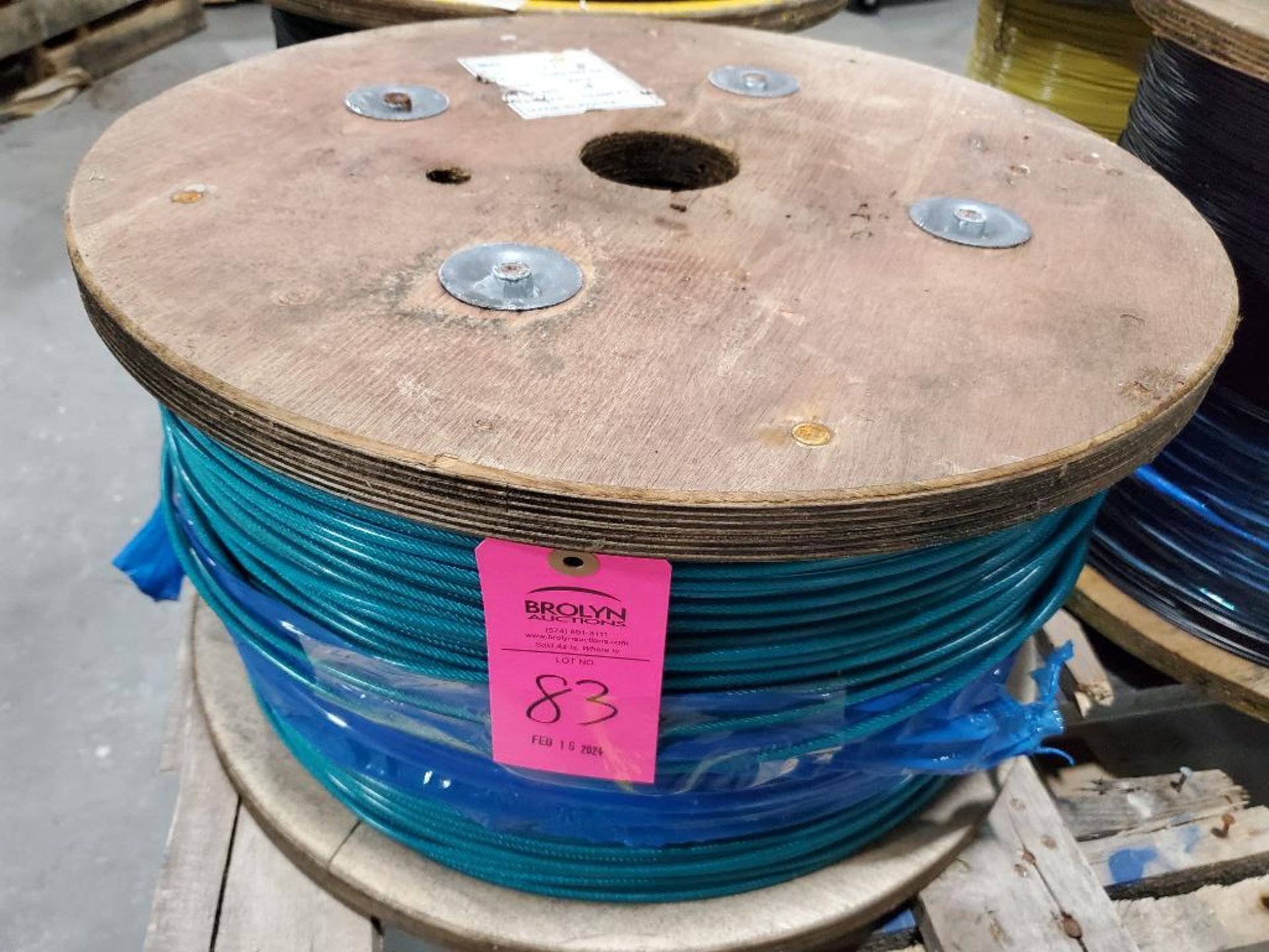 Roll of coated multi-strand steel cable.