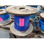 Roll of coated multi-strand steel cable.