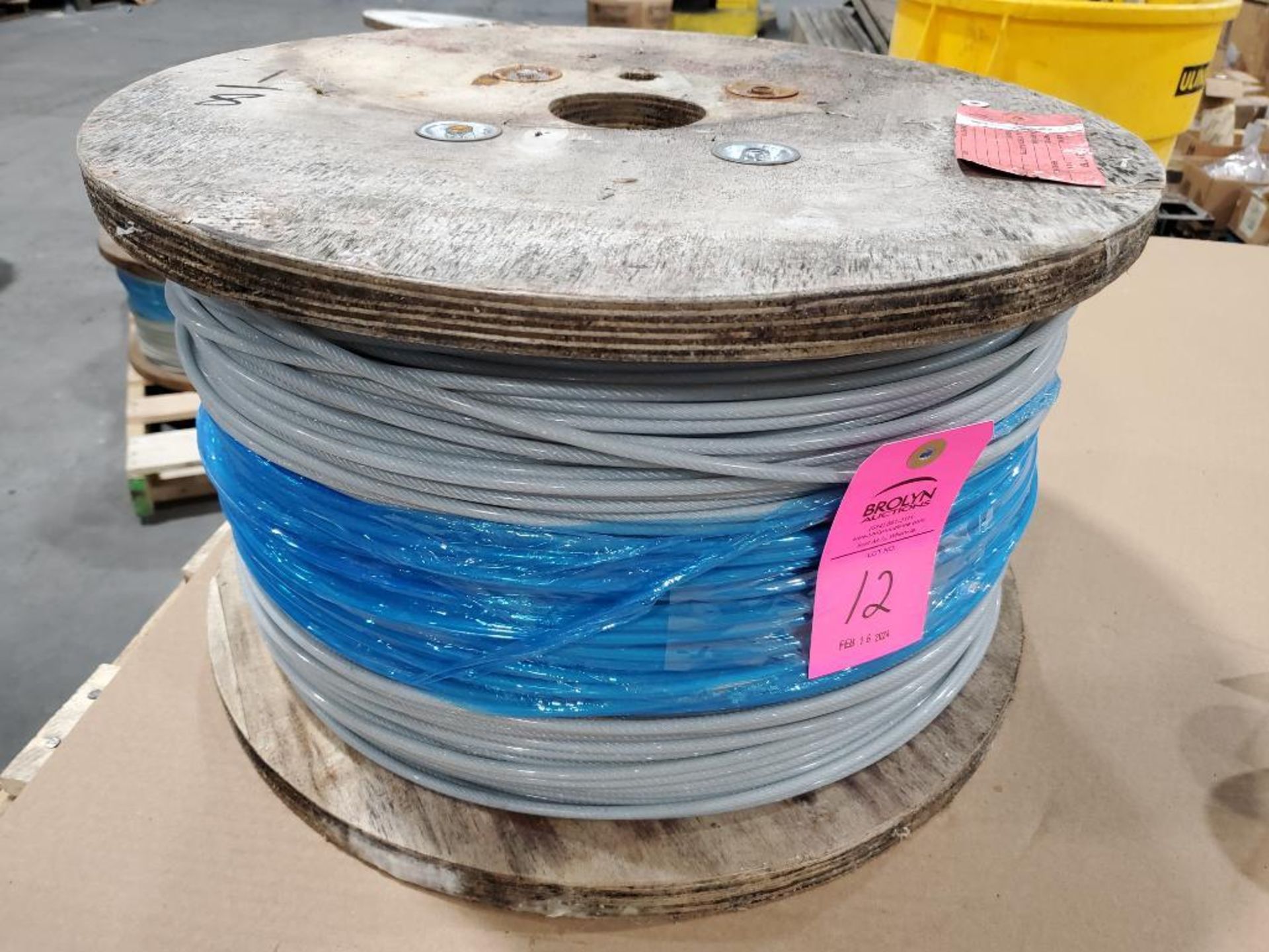 Roll of coated multi-strand steel cable.