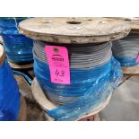 Roll of coated multi-strand steel cable.