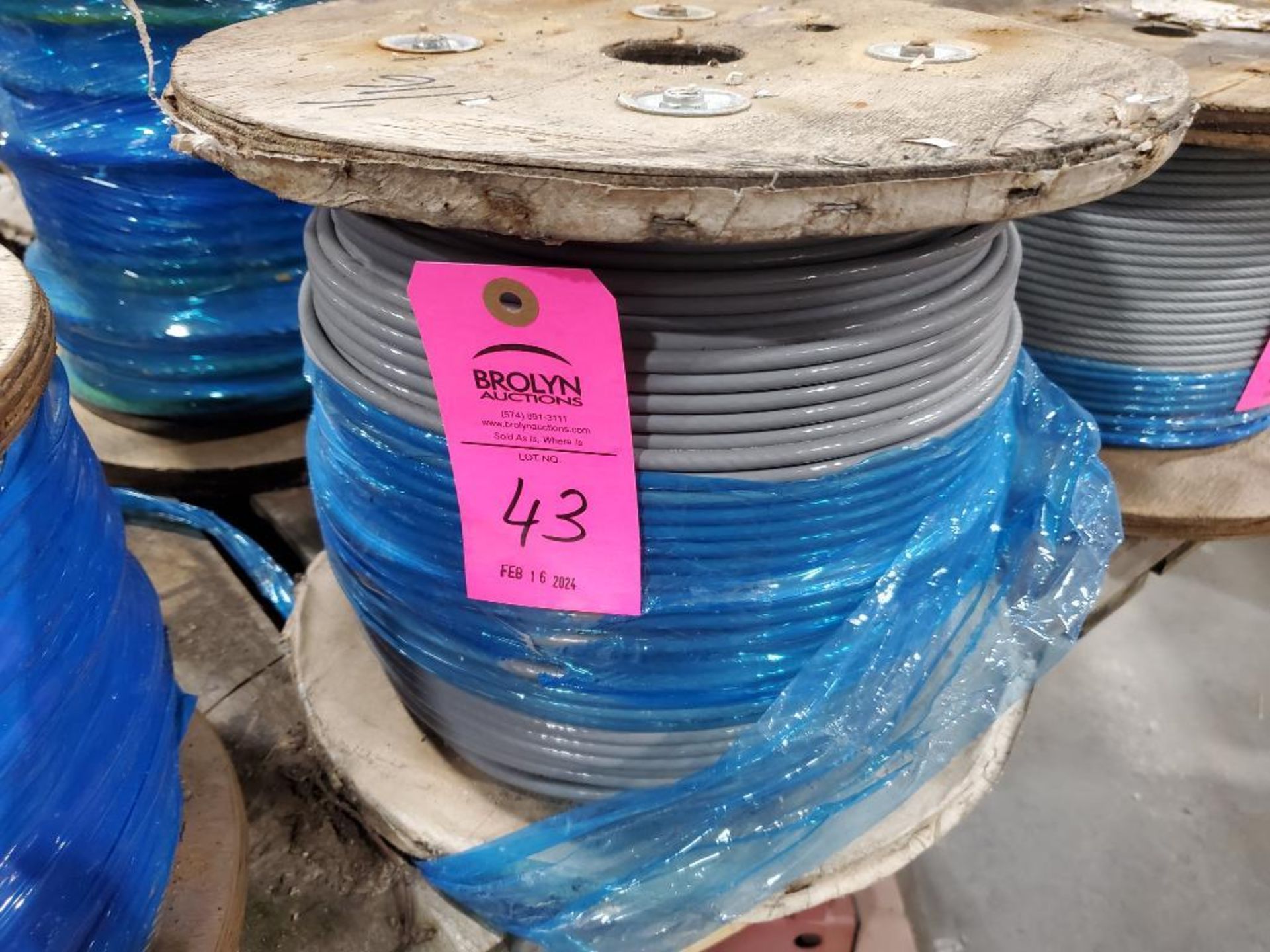 Roll of coated multi-strand steel cable.