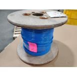 Roll of coated multi-strand steel cable.