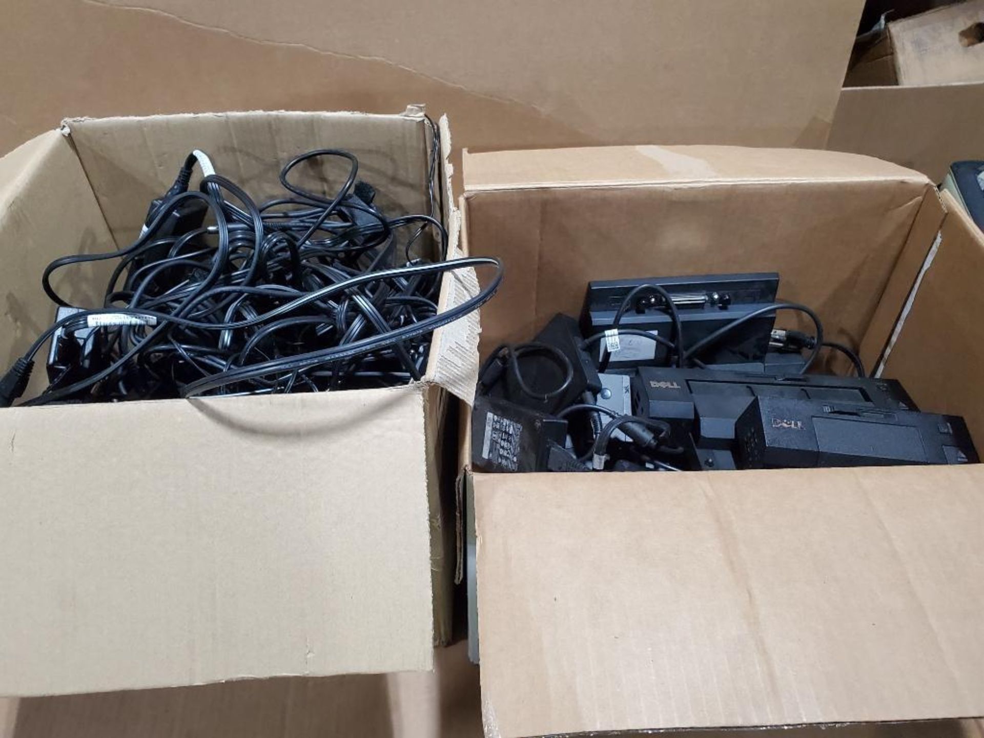 Assorted Dell docking stations and power supplies.