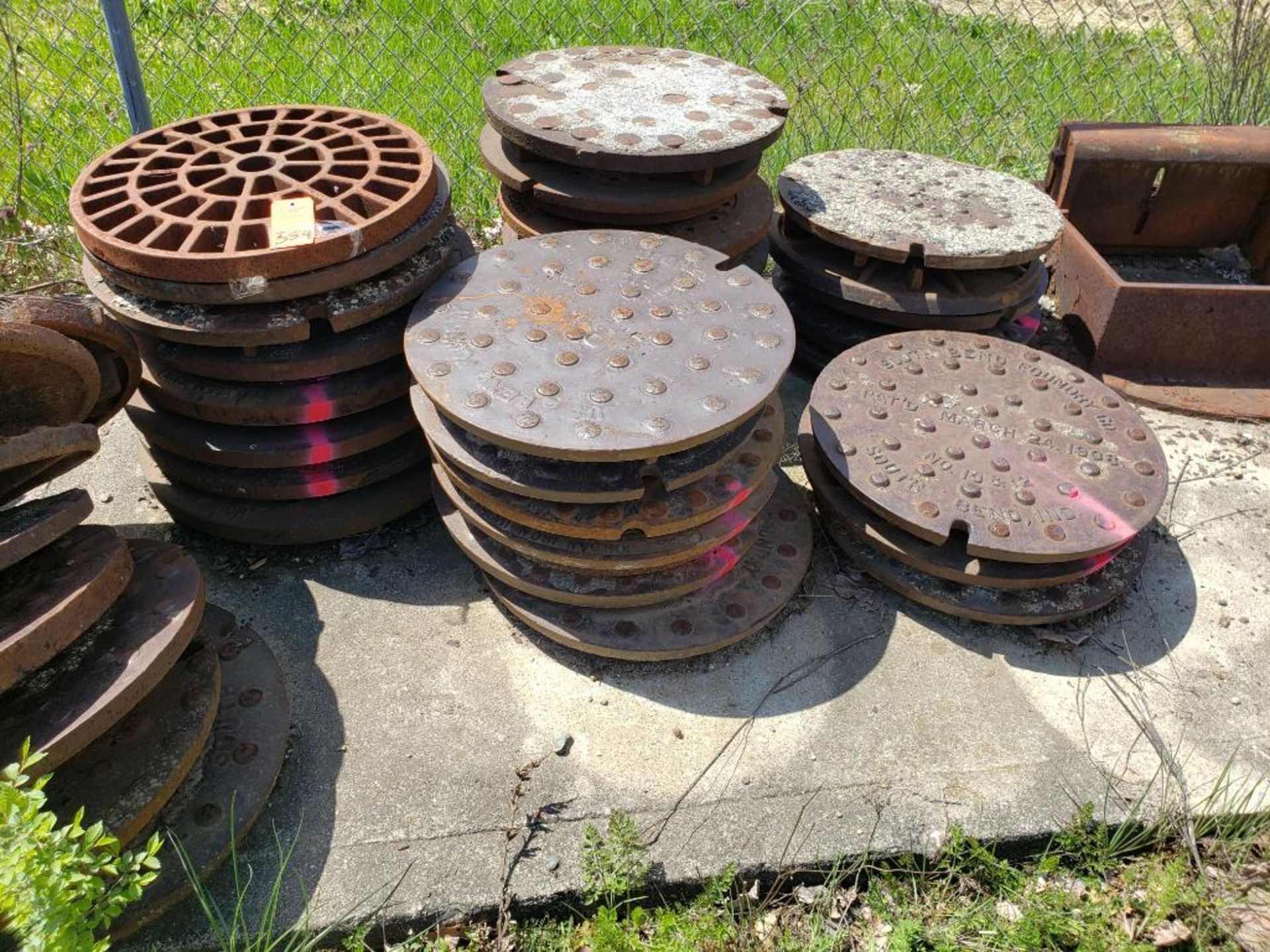 Assorted man hole covers. (units with pink marking are NOT included in lot)
