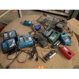 Large assortment of battery chargers, batteries, and electrical.