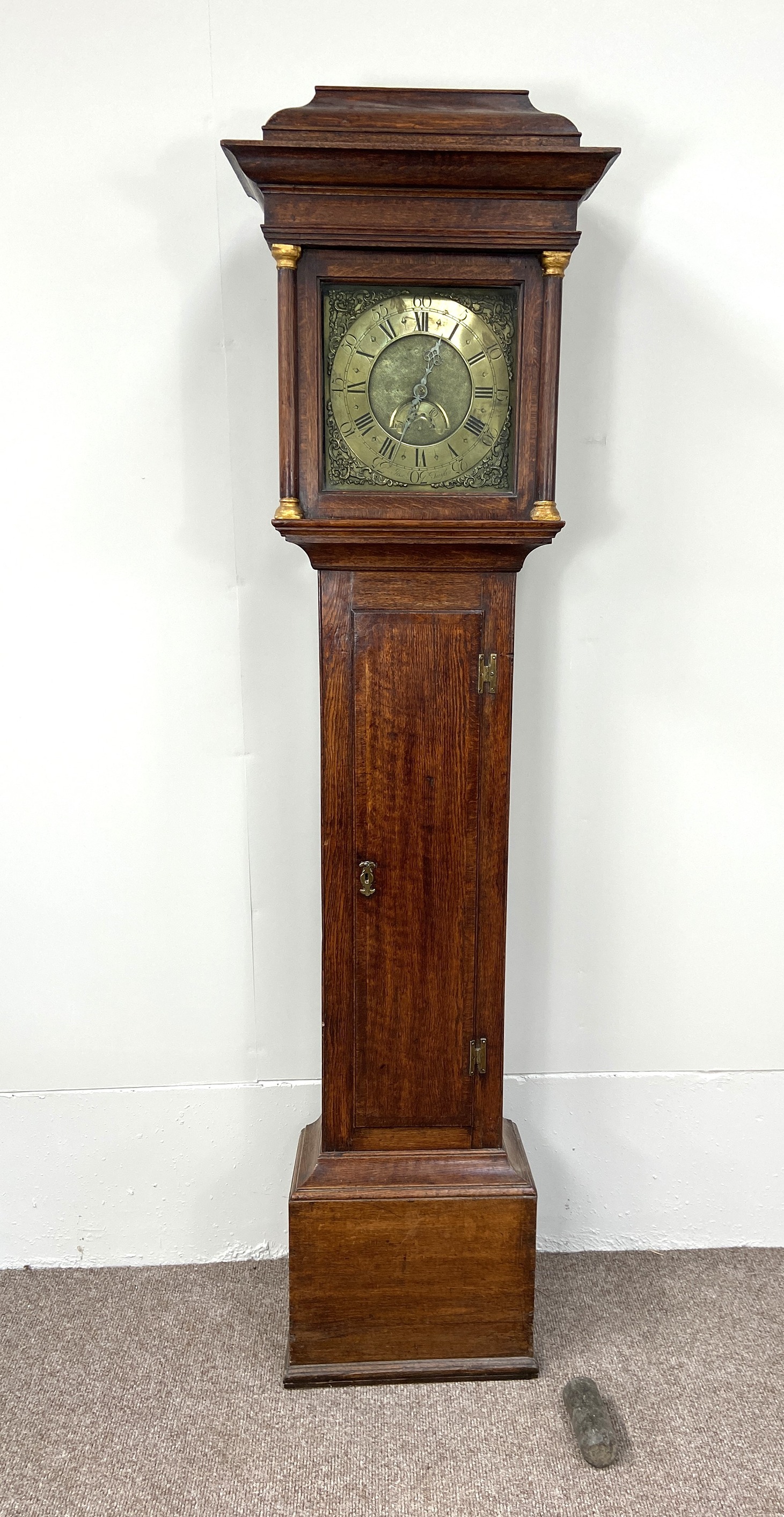 An early 18th century oak longcase clock, by Joseph Taylor, in an architectural provincial caddy