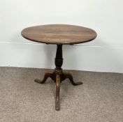 A handy George III provincial oak wine table, with circular top on a baluster pillar and tripod