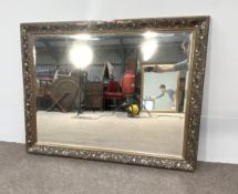 A large decorative gilt framed wall mirror, with scroll embossed frame (some damages to frame)